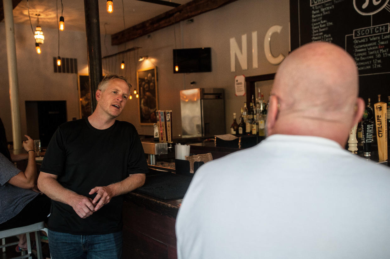 Chris Sommers, owner of Pi Pizzeria, talks to supportive customers in his Central West End location in St. Louis on Wednesday.