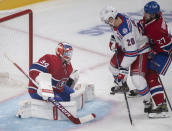 Montreal Canadiens goaltender Jake Allen is scored on by New York Rangers' Chris Kreider (20) as Canadiens' Alexander Romanov defends during the second period of an NHL hockey game Saturday, Oct. 16, 2021, in Montreal. (Graham Hughes/The Canadian Press via AP)