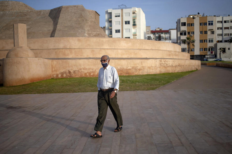 A man wearing a face mask to prevent the spread of coronavirus walks outside a fort that was converted into a photography museum overlooking the Atlantic Ocean, in Rabat, Morocco, Tuesday, Sept. 22, 2020. (AP Photo/Mosa'ab Elshamy)