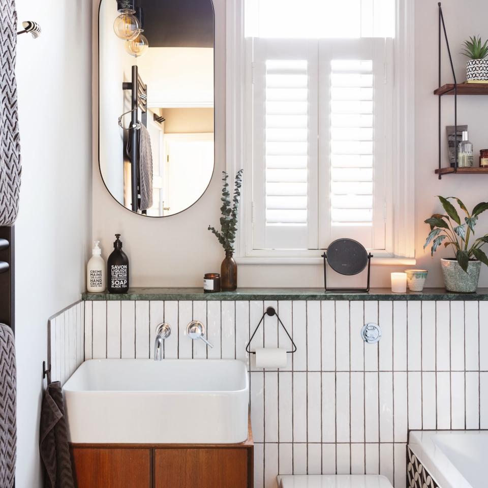 white tiles and black grouting in small bathroom