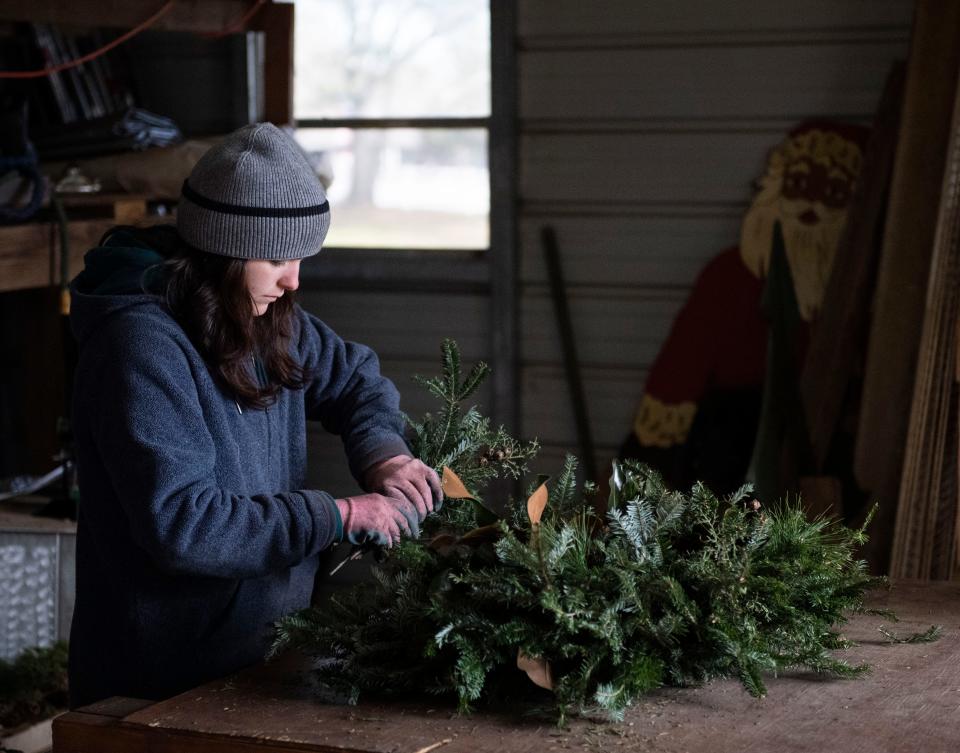 Courtney Ellison, 18, of Greenville assembles wreaths at Mystic Farm, in Greenville, ,Monday, November 30, 2021. 