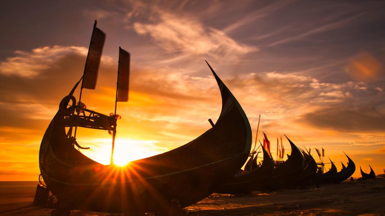 silhouette of moored viking ships on beach against sky during sunset,bangladesh