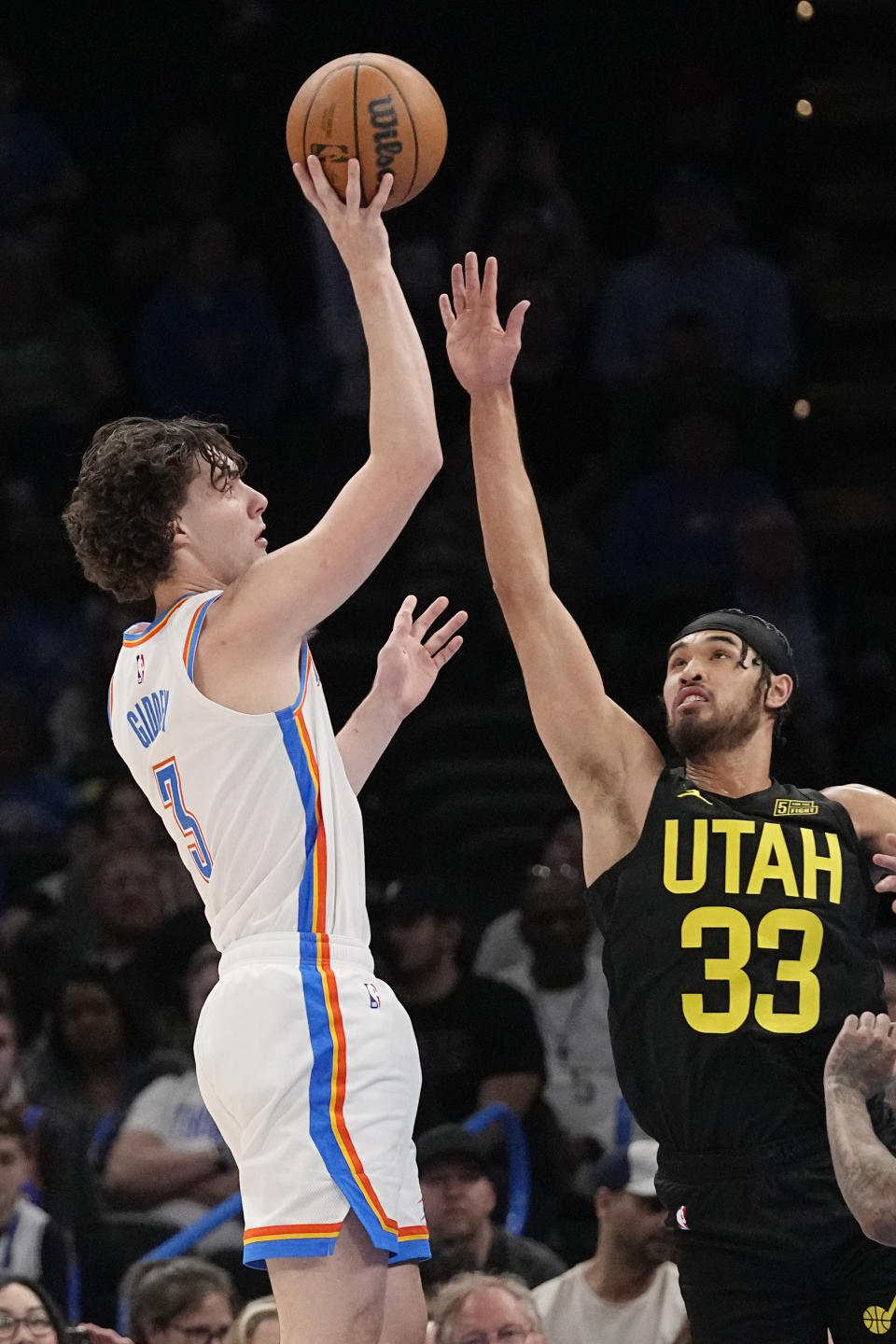 Oklahoma City Thunder guard Josh Giddey (3) shoots over Utah Jazz guard Johnny Juzang (33) in the second half of an NBA basketball game Sunday, March 5, 2023, in Oklahoma City. (AP Photo/Sue Ogrocki)