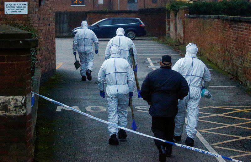 Forensic officers walk outside a property, which is being searched in connection with yesterday's stabbing on London Bridge, in which two people were killed, in Stafford