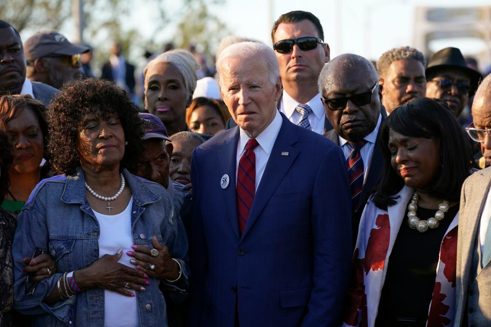 President Joe Biden takes part in a prayer after walking across the Edmund Pettus Bridge in Selma, Alabama on March 5, 2023, to commemorate the 58th anniversary of "Bloody Sunday," a landmark event of the civil rights movement. With Biden was Rep. Jim Clyburn, D-S.C., right.