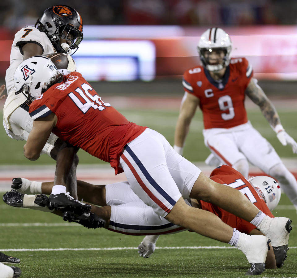 Arizona defensive lineman Ta'ita'i Uiagalelei (46) stops Oregon State wide receiver Silas Bolden (7) during the second quarter of an NCAA college football game Saturday, Oct. 28, 2023, in Tucson, Ariz. (Kelly Presnell/Arizona Daily Star via AP)