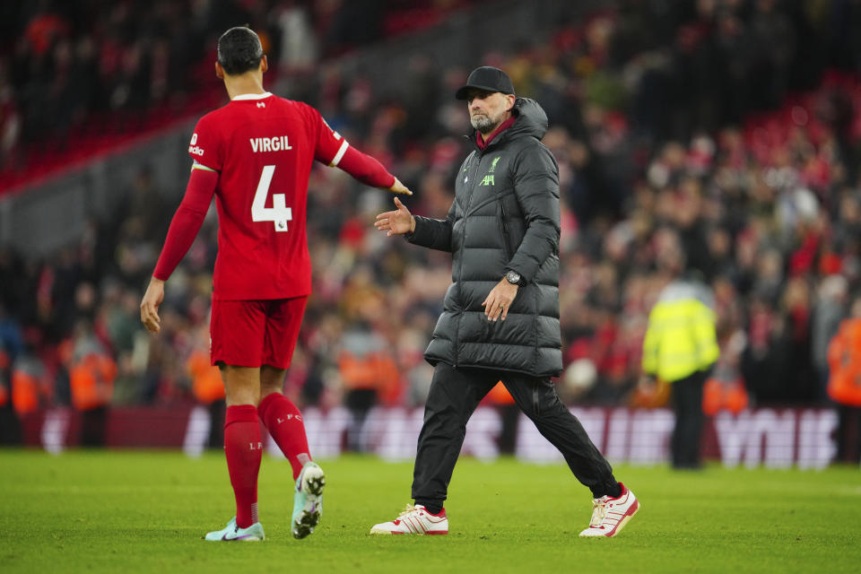 Liverpool's manager Jurgen Klopp, right, and Liverpool's Virgil van Dijk shake hands after the English Premier League soccer match between Liverpool and Manchester United at the Anfield stadium in Liverpool, England, Sunday, Dec.17, 2023. (AP Photo/Jon Super)