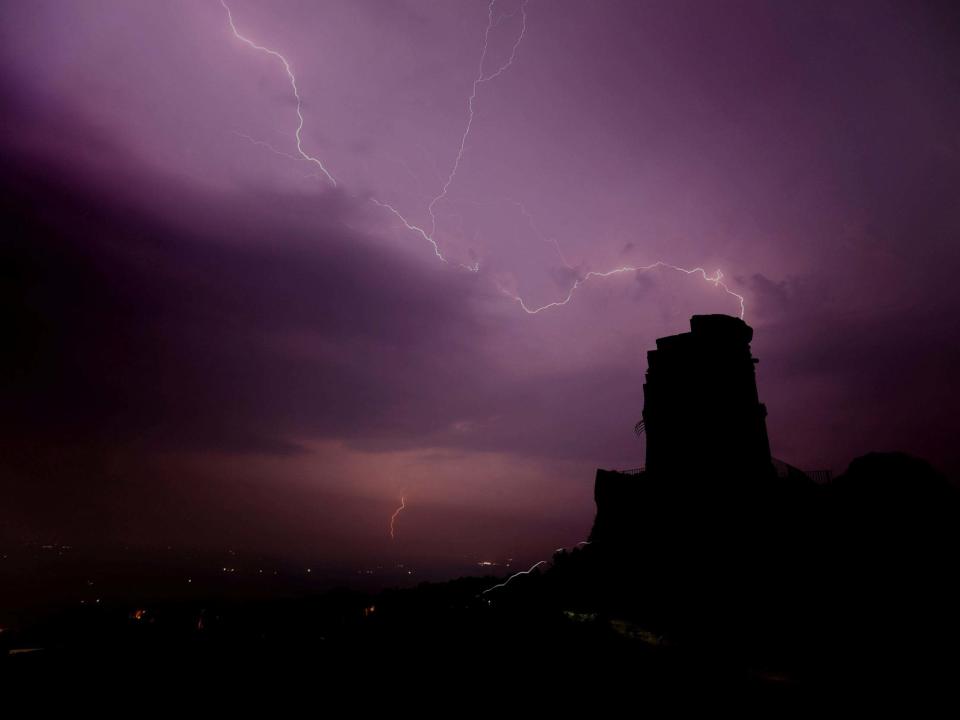 Lightning is seen over Mow Cop, Staffordshire: REUTERS