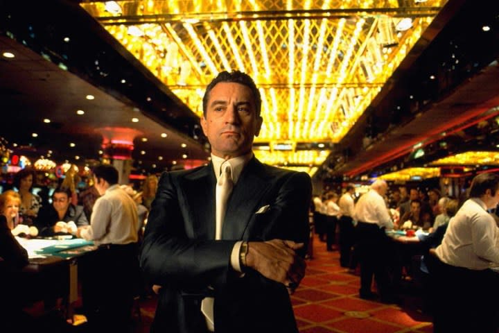 Robert De Niro stands under casino lights in Casino.