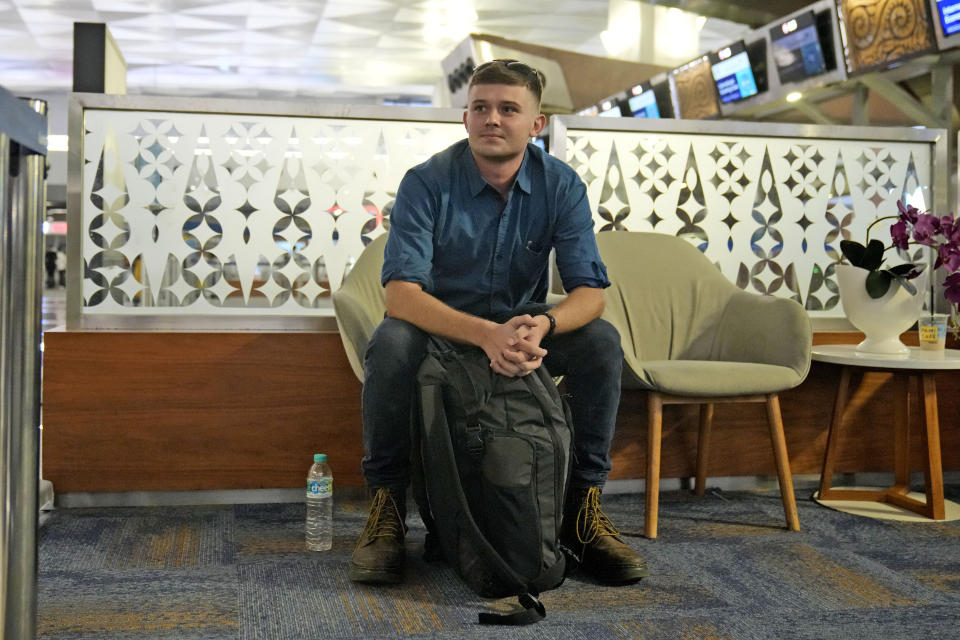Australian national Bodhi Mani Risby-Jones from Queensland waits waits for check in at Soekarno-Hatta International Airport in Tangerang, Indonesia, Saturday, June 10, 2023. Indonesia’s authorities are deporting an Australian surfer who apologized for attacking several people while drunk and naked in the deeply conservative province of Aceh. Bodhi Mani Risby-Jones was detained in late April on Simeulue Island, a surf resort, after police accused him of going on a drunken rampage that left a fisherman with serious injuries. (AP Photo/Dita Alangkara)