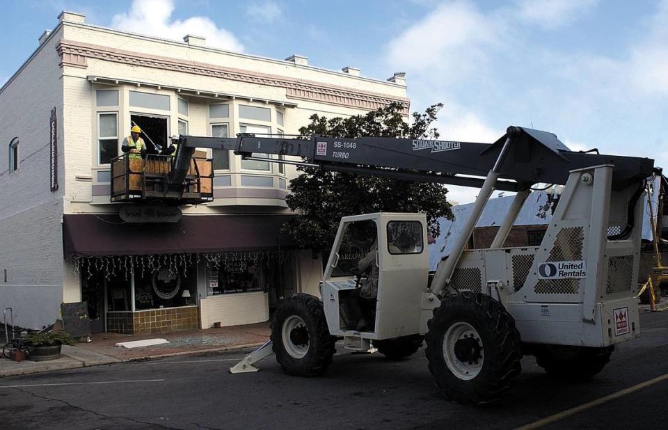 Workers retrieved items from businesses on 12th Street in Paso Robles on Jan. 28, 2004, using a lift and breaking windows to gain access. This building was red tagged after the San Simeon Earthquake.