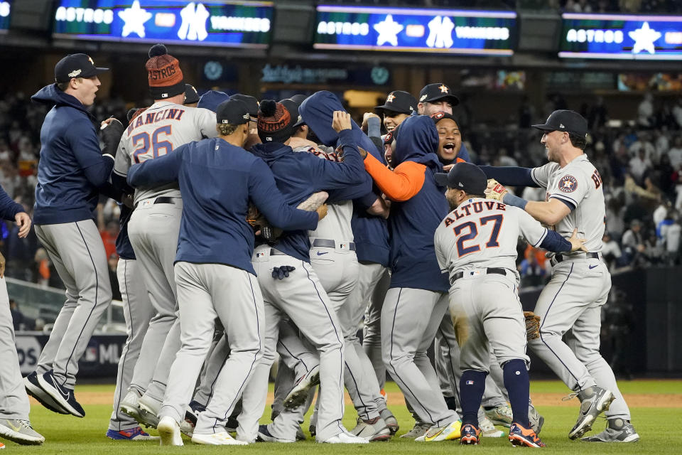 The Houston Astros celebrate after defeating the New York Yankees 6-5 to win Game 4 and the American League Championship baseball series, Monday, Oct. 24, 2022, in New York. (AP Photo/John Minchillo)