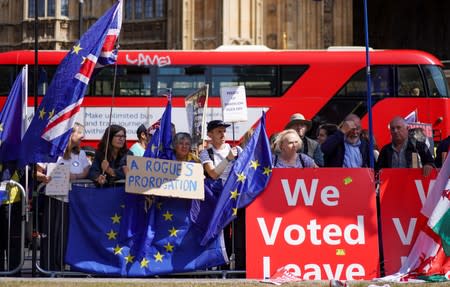 Anti-Brexit protesters stand outside the Houses of Parliament in London