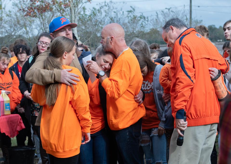 Principal Stephen Shell, right, comforts the Collier-Comer family during a memorial ceremony for Haleigh Collier at Pace High School on Thursday, Nov. 16, 2023. Collier, a 17-year-old Junior, passed away during a tragic ATV accident on Sunday, Nov. 5, 2023.