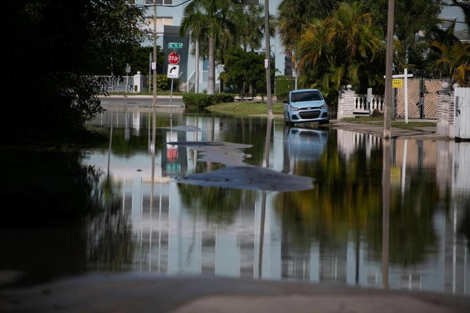 A lone car is parked on a flooded street near the intersection of NE Bayshore Dr and NE 78 Rd Tuesday afternoon, November 9, 2021. The flooded streets were due to King Tides.