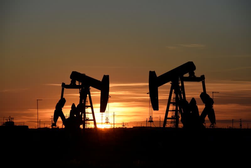 FILE PHOTO: Pump jacks operate at sunset in an oil field in Midland