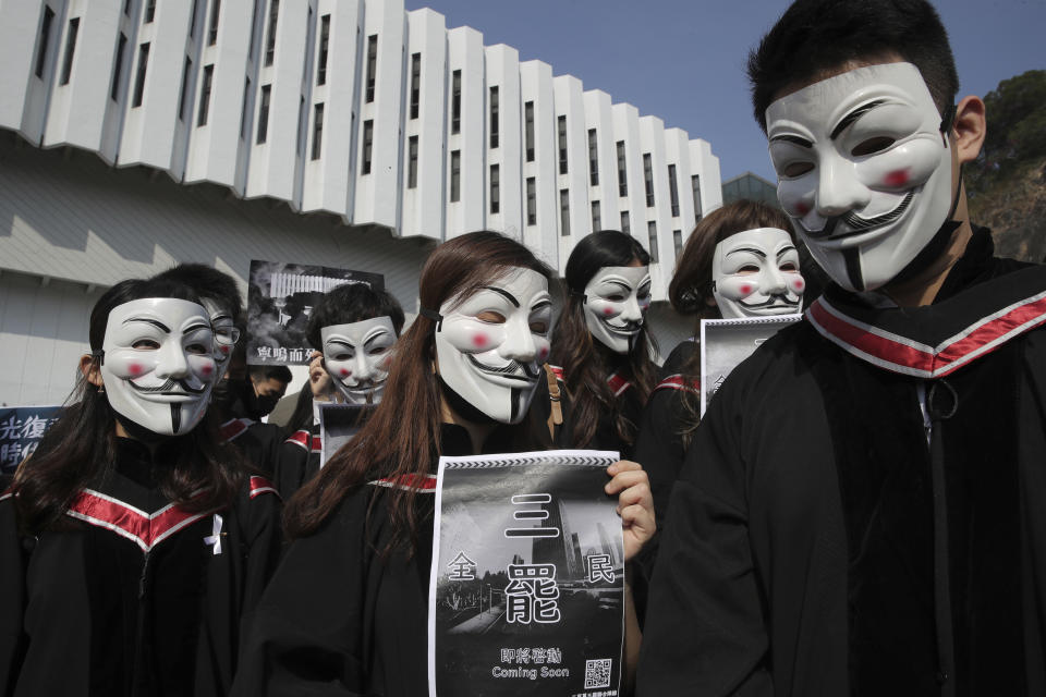 University students wearing Guy Fawkes masks during an protest before their graduation ceremony at the Chinese University of Hong Kong, in Hong Kong, Thursday, Nov. 7, 2019. (AP Photo/Kin Cheung)