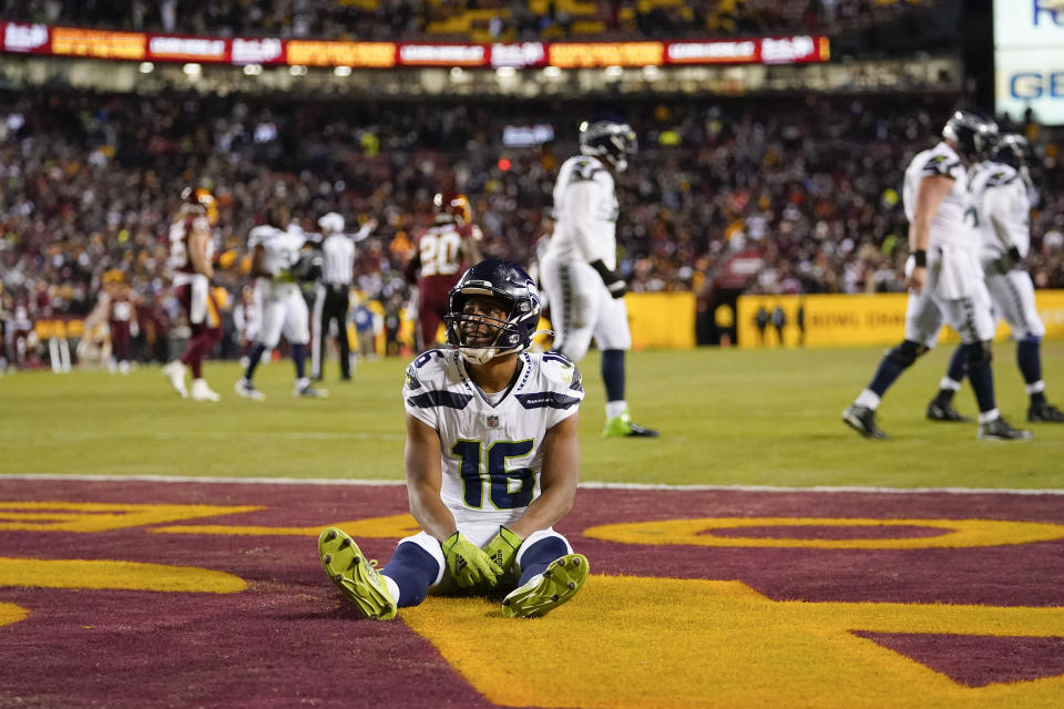 Seattle Seahawks wide receiver Tyler Lockett (16) sits in the end zone after Washington Football Team cornerback Kendall Fuller (29) made an interception against the Seahawks near the end of the second half of an NFL football game, Monday, Nov. 29, 2021, in Landover, Md. Washington won 17-15. (AP Photo/Julio Cortez)