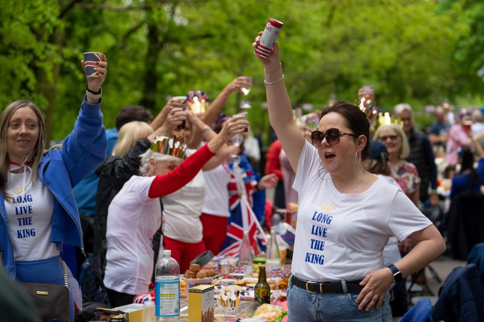 People cheer for King Charles III and Queen Camilla during the Big Lunch celebrations in Regent's Park, London (AP)