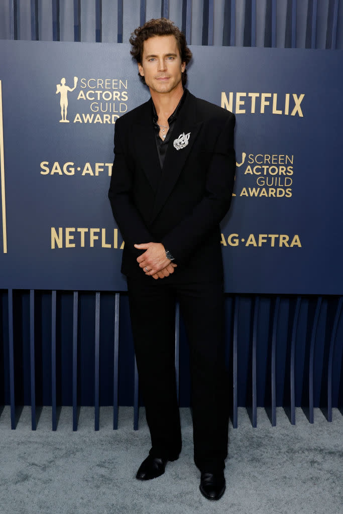 Matt Bomer in a velvet tuxedo with decorative pin