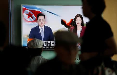 Passengers watch a TV screen broadcasting a news report on North Korea firing three ballistic missiles into the sea off its east coast, at a railway station in Seoul, South Korea, September 5, 2016. REUTERS/Kim Hong-Ji