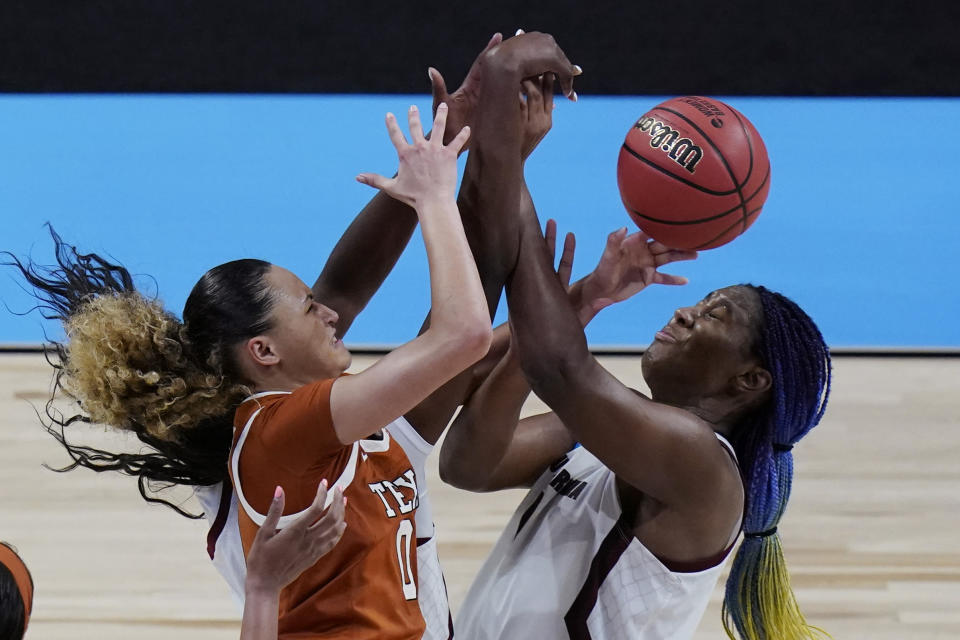 Texas guard Celeste Taylor (0) and South Carolina forward Aliyah Boston (4) battle for a rebound during the second half of a college basketball game in the Elite Eight round of the women's NCAA tournament at the Alamodome in San Antonio, Tuesday, March 30, 2021. (AP Photo/Eric Gay)