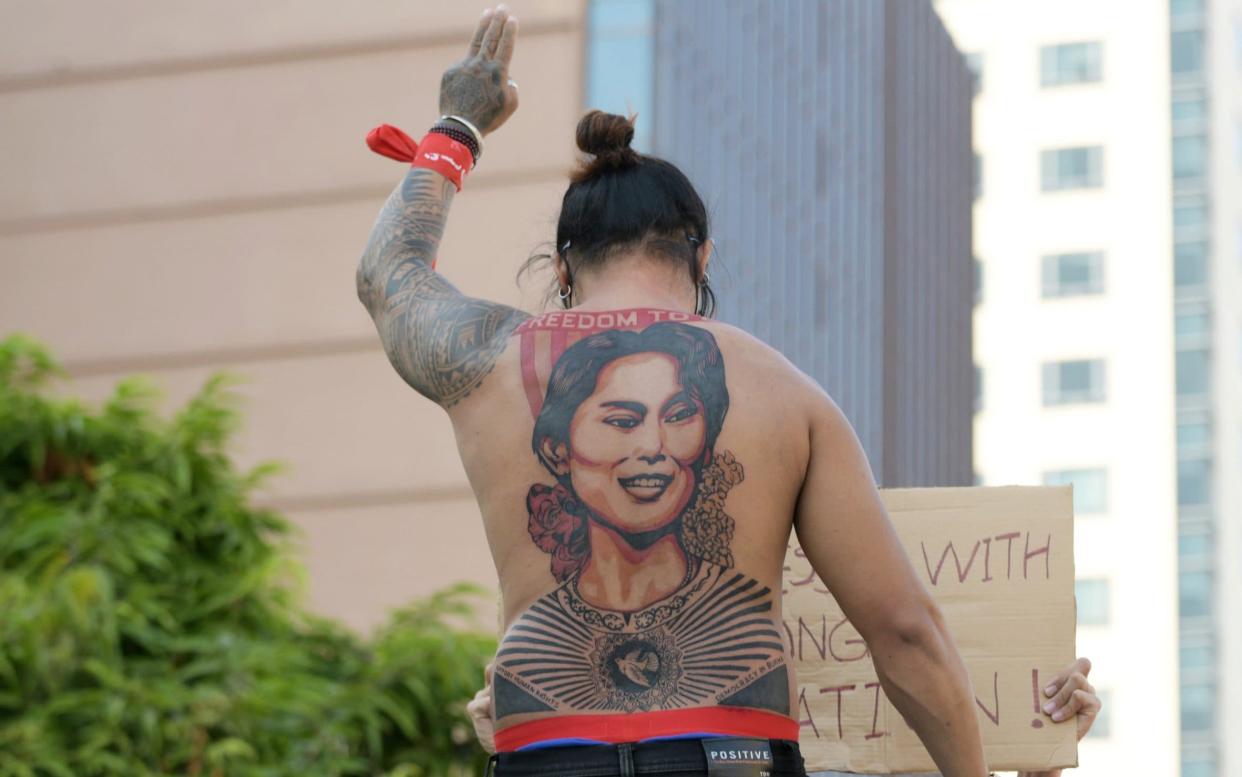 A man with a tattoo of Aung San Suu Kyi takes part in a protest against the military coup - REUTERS