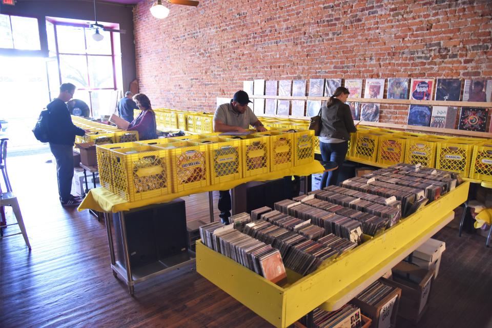 Customers browse a  range of vintage vinyl at Astro Record Store in Bastrop.