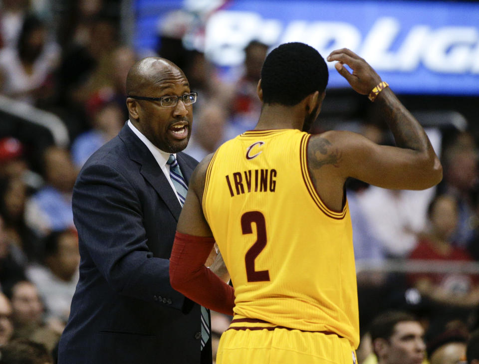 Cleveland Cavaliers's Mike Brown, left, talks to Kyrie Irving during the first half of an NBA basketball game against the Los Angeles Clippers on Sunday, March 16, 2014, in Los Angeles. (AP Photo/Jae C. Hong)