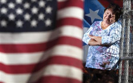 Marianne Ward poses for a portrait near a U.S. flag in the Staten Island borough of New York, September 20, 2013. REUTERS/Carlo Allegri