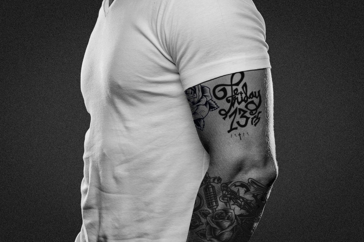 A man with a sleeve of tattoos.
