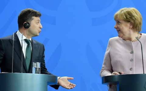 Angela Merkel and Ukraine's new President Volodymyr Zelenskiy held a press conference after the incident - Credit: TOBIAS SCHWARZ/AFP/Getty Images