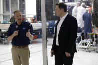 NASA Administrator Jim Bridenstine, left, talks with SpaceX chief engineer Elon Musk, right, in front of the Crew Dragon spacecraft, about the progress to fly astronauts to and from the International Space Station, from American soil, as part of the agency's commercial crew program at SpaceX headquarters, in Hawthorne, Calif., Thursday, Oct. 10, 2019. (AP Photo/Alex Gallardo)