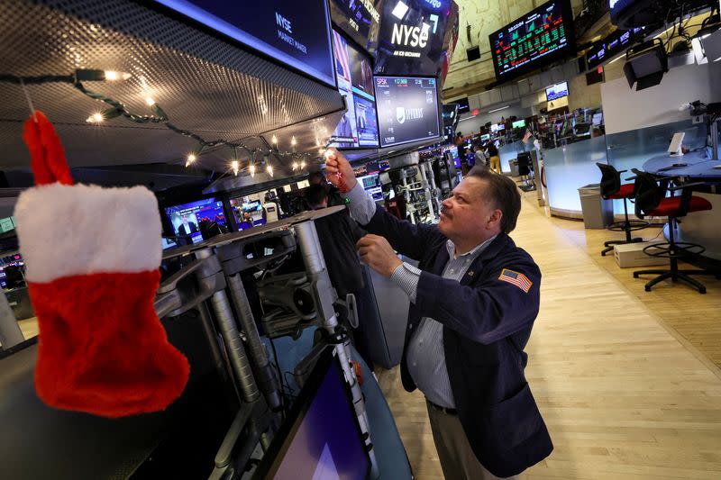 FILE PHOTO: Traders work on the floor of the NYSE in New York