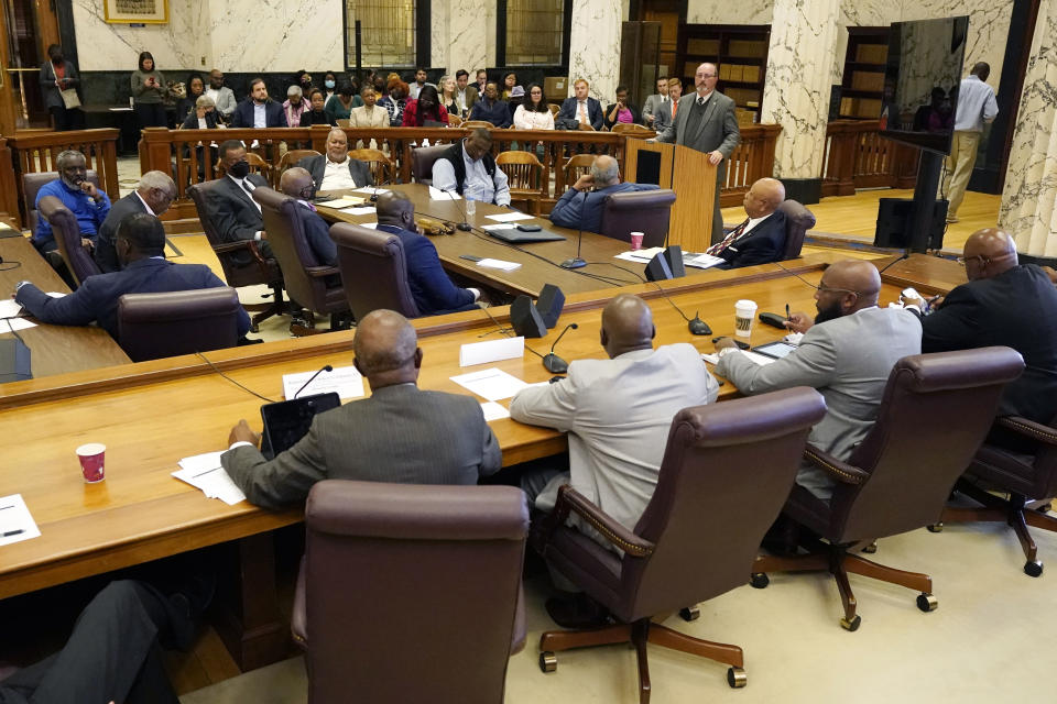 Robert Anderson, executive director of the Mississippi Department of Human Services, at the podium, addresses members of the Mississippi House and Senate Democratic Caucuses, during a public hearing, Tuesday, Oct. 18, 2022 at the Capitol, to gain a better understanding of the welfare scandal. (AP Photo/Rogelio V. Solis)