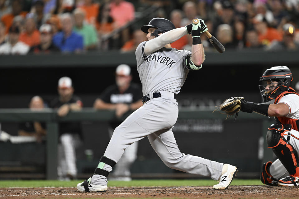 New York Yankees' Harrison Bader follows through on a sac fly to score Giancarlo Stanton in the fifth inning of a baseball game Sunday, July 30, 2023, in Baltimore. The Orioles won 9-3. (AP Photo/Gail Burton)