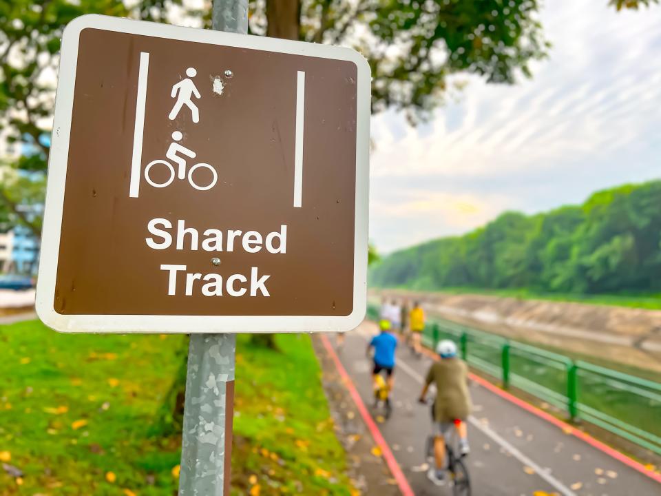 A sign describing shared tracks for pedestrians and cyclists in