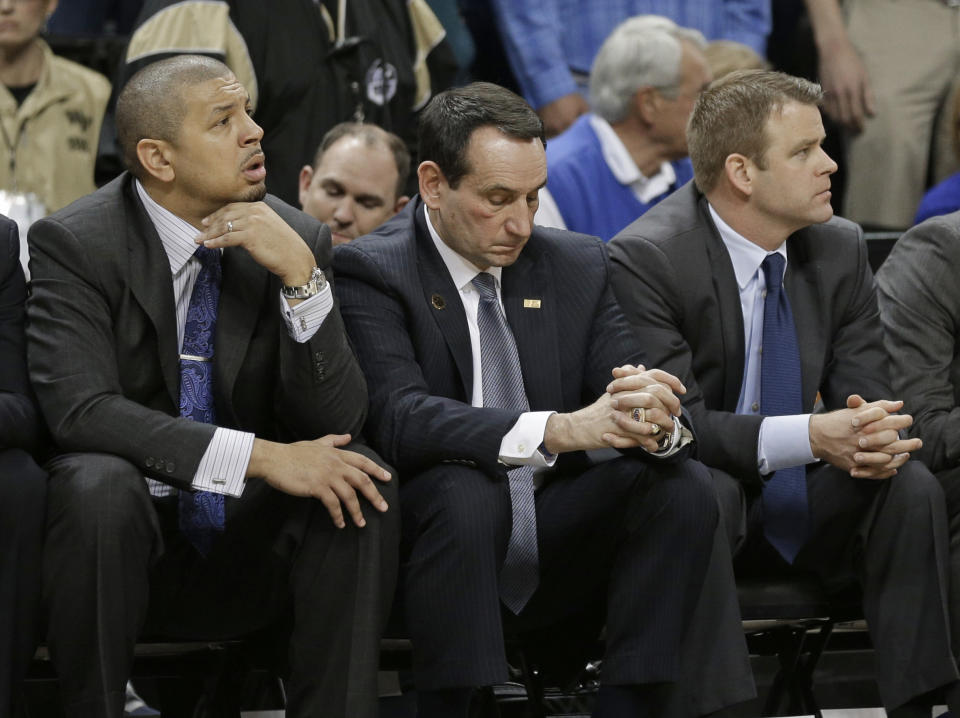 Duke head coach Mike Krzyzewski, center, and assistant coaches Jeff Capel, left, and Steve Wojciechowski, right, watch the final minute of an NCAA college basketball game against Wake Forest in Winston-Salem, N.C., Wednesday, March 5, 2014. Wake Forest won 82-72. (AP Photo/Chuck Burton)