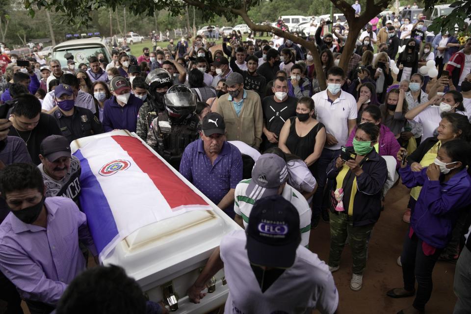 Pallbearers carry the coffin that contain the remains of Leidy Vanessa Luna Villalba outside her home, in Eugenio Garay, Paraguay, Tuesday, July 13, 2021. Luna Villalba, a nanny employed by the sister of Paraguay's first lady Silvana Lopez Moreira, was among those who died in the Champlain Towers South condominium collapse in Surfside, Florida on June 24. (AP Photo/Jorge Saenz)