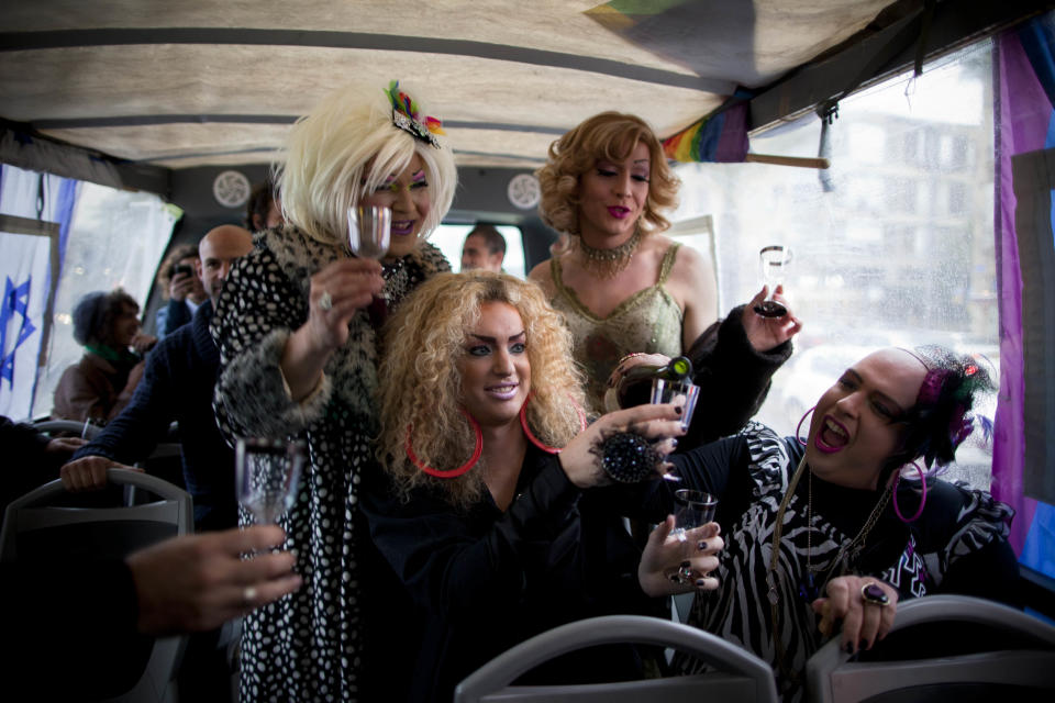 In this Wednesday, Jan. 11, 2012 photo, Israeli female impersonators celebrate the announcement of Tel Aviv as the Best Gay City of 2011 after it won first place at an international competition, outside the municipality building in Tel Aviv, Israel. Thanks to a balmy climate, a vibrant nightlife and a creative, government-backed branding campaign, Tel Aviv has become one of the world's top gay tourist destinations. (AP Photo/Oded Balilty)