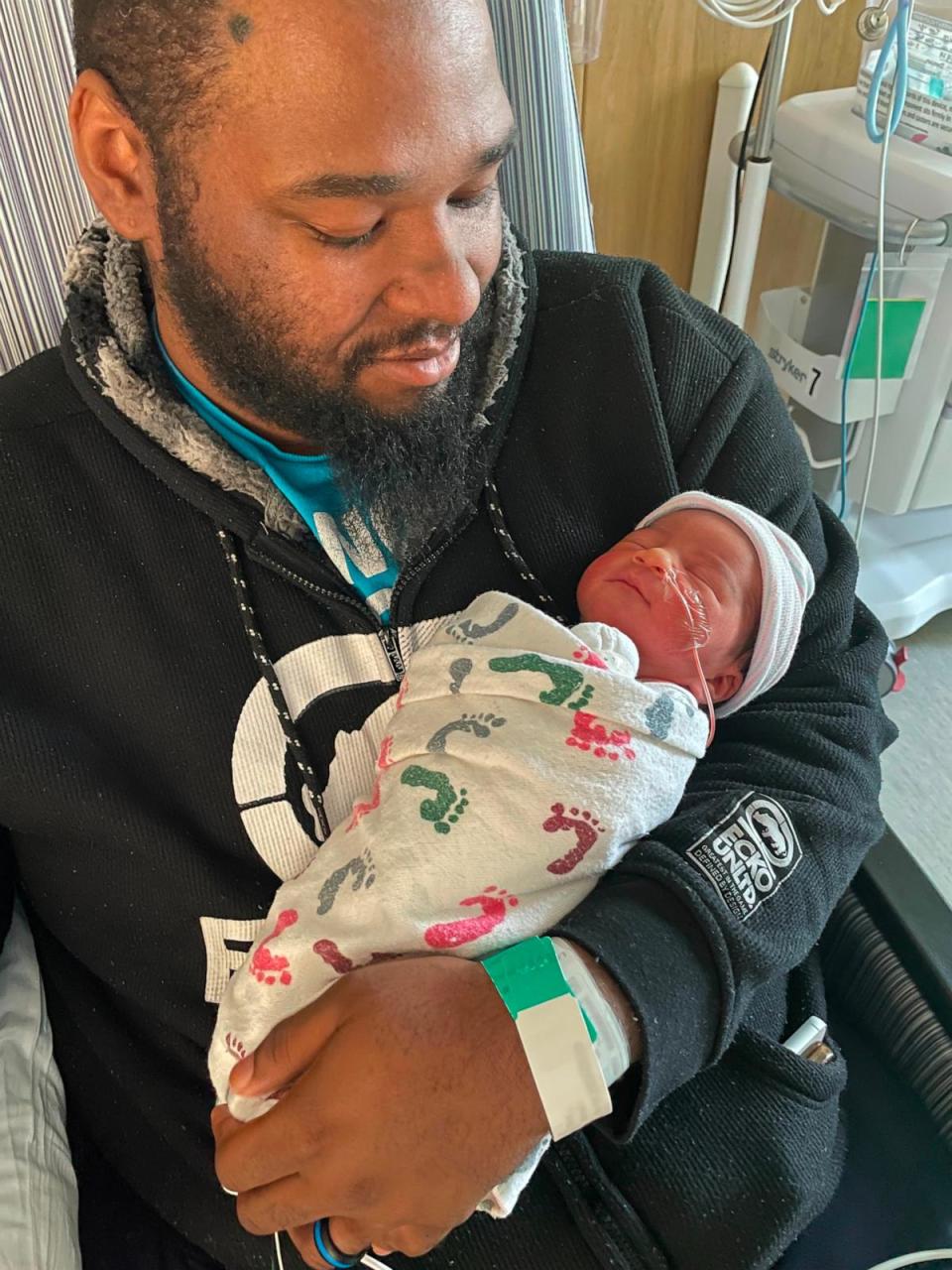 PHOTO: Elliott McNeil holds his newborn son Kairo. (Cone Health)