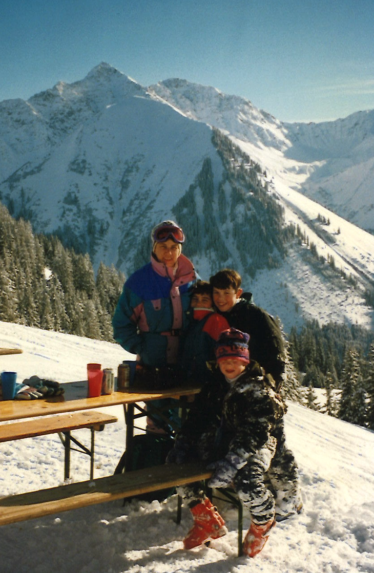 Skiing family eating lunch on the slopes