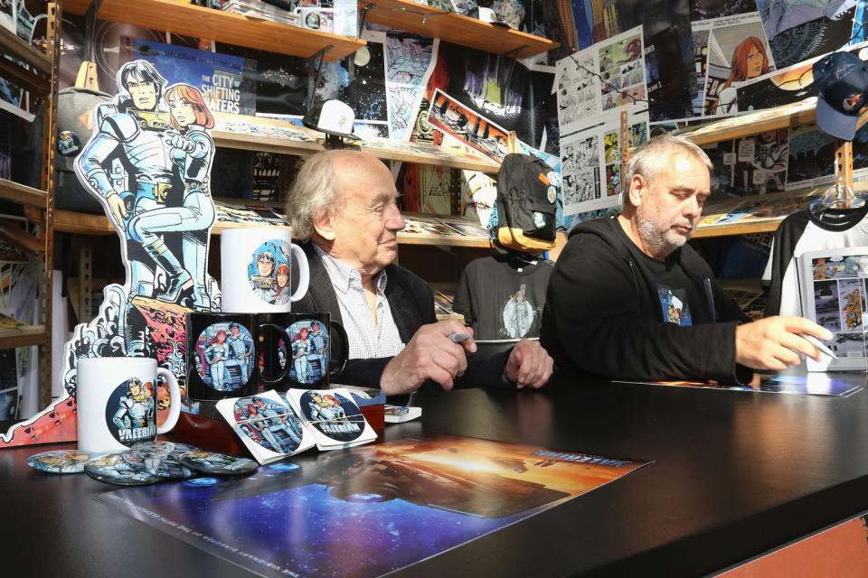 "Valerian" director Luc Besson and the comic's co-creator Jean-Claude Mézières met fans to sign the film's newly-released poster at New York Comic Con on Thursday, Oct. 6. <cite>Janette Pellegrini / Getty Images</cite>