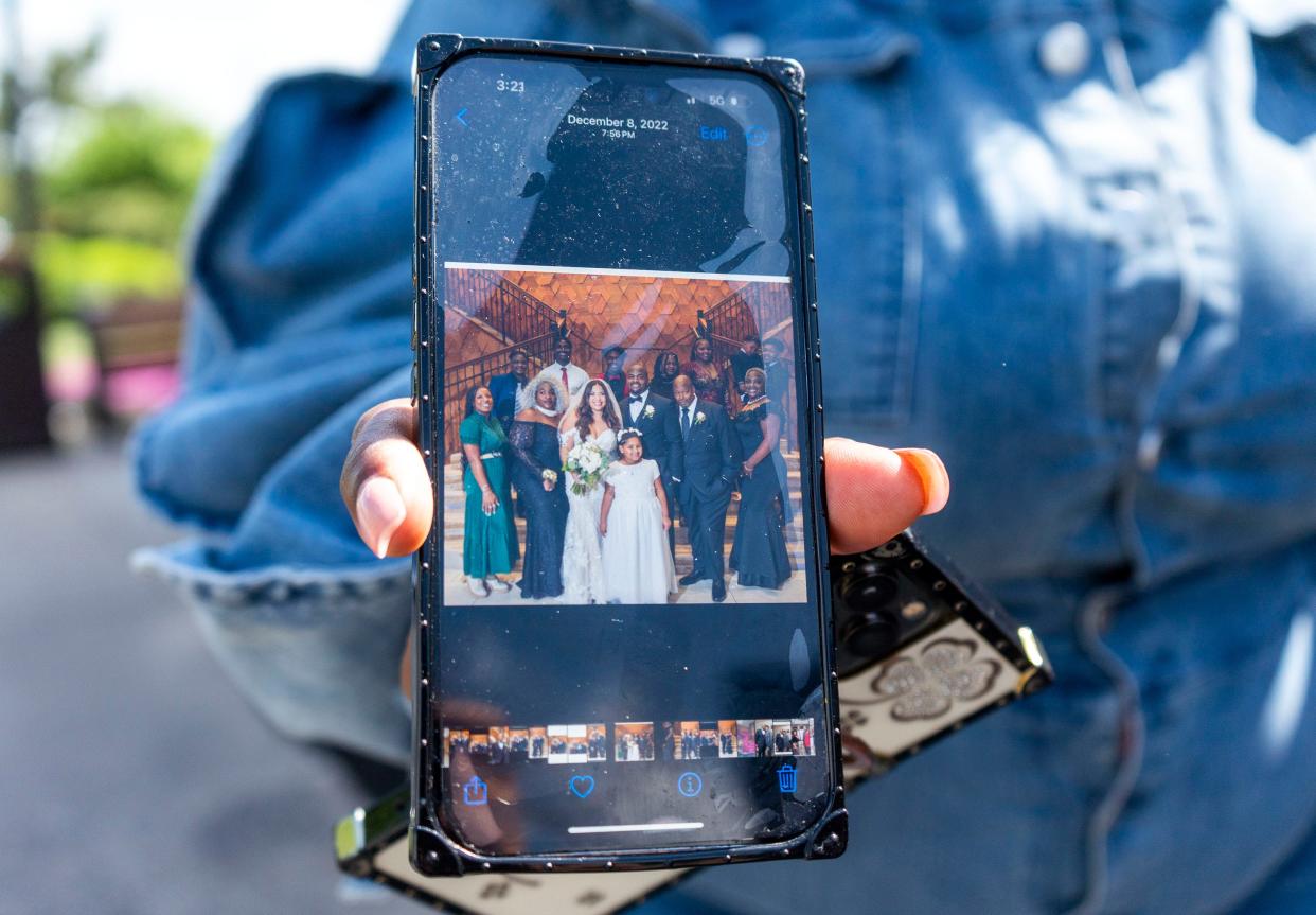 Tyronda Majors, a mother of 10 children, shows a photo of them all she keeps on her phone in Levittown on Wednesday, May 8, 2024.