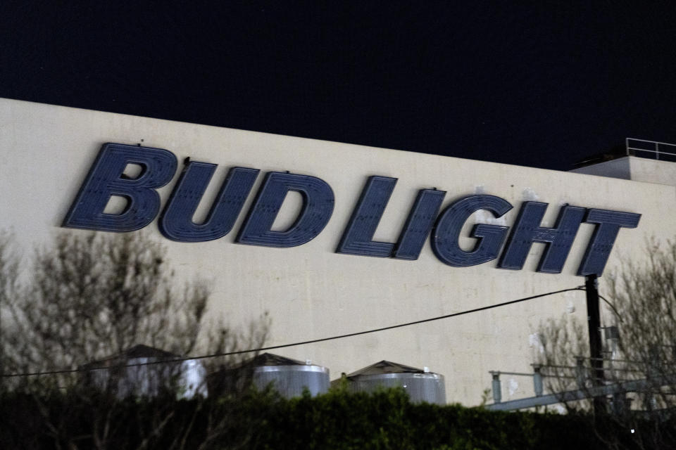 A Bud Light sign is illuminated by street lights on the side of the Anheuser Busch factory in the Van Nuys section of Los Angeles on Wednesday, Feb. 28, 2024. A standoff between brewery workers and Anheuser-Busch might lead to the first strike by the company's unionized employees in the U.S. since 1976. But fans of Budweiser, Bud Light, Michelob and other beers don't need to worry about going dry. (AP Photo/Richard Vogel)