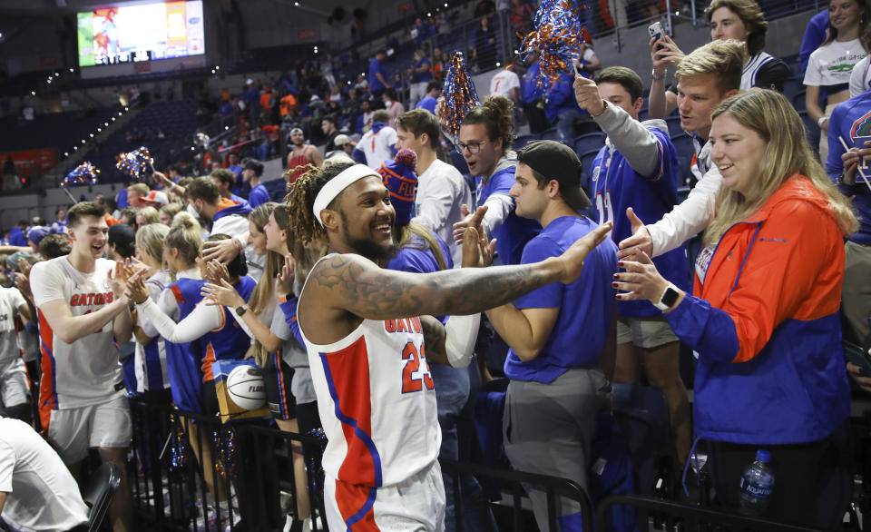 Florida guard Brandon McKissic (23) celebrates with fans after an NCAA college basketball game against Troy, Sunday, Nov. 28, 2021, in Gainesville, Fla. (AP Photo/Matt Stamey)