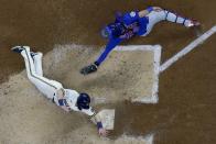 Milwaukee Brewers' Billy McKinney slides safely past Chicago Cubs catcher Austin Romine during the sixth inning of a baseball game Wednesday, April 14, 2021, in Milwaukee. McKinney scored from second on a hit by Corbin Burnes. (AP Photo/Morry Gash)