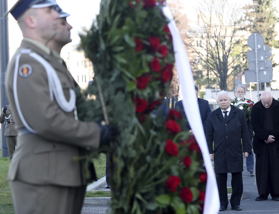The head of Poland's ruling conservative party, Jaroslaw Kaczynski, laying a wreath during a scaled-down observance in memory of his twin brother, the late President Lech Kaczynski, and 95 other prominent Poles who were killed in a plane crash in Russia 10 years ago, at the late president's monument in Warsaw, Poland, on Friday, April 10, 2020. The observances were scaled down to just a few people and no crowd, under social distancing regulations against the spread of the coronavirus. The new coronavirus causes mild or moderate symptoms for most people, but for some, especially older adults and people with existing health problems, it can cause more severe illness or death.(AP Photo/Czarek Sokolowski)