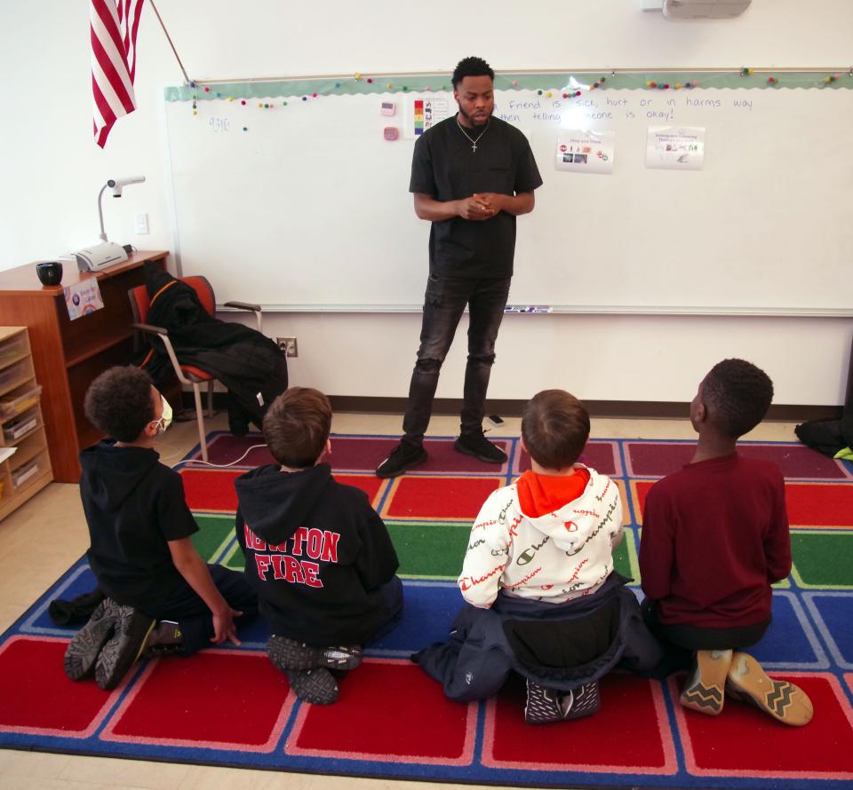 Sean Paige of Brockton, a behavioral and social educator at Angier Elementary School in Newton, works with some students in his classroom on Tuesday, Jan. 24, 2023.