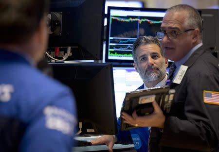 Traders work on the floor of the New York Stock Exchange November 17, 2014. REUTERS/Brendan McDermid